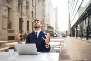 man suffering from one of the cons of online learning - poor wifi